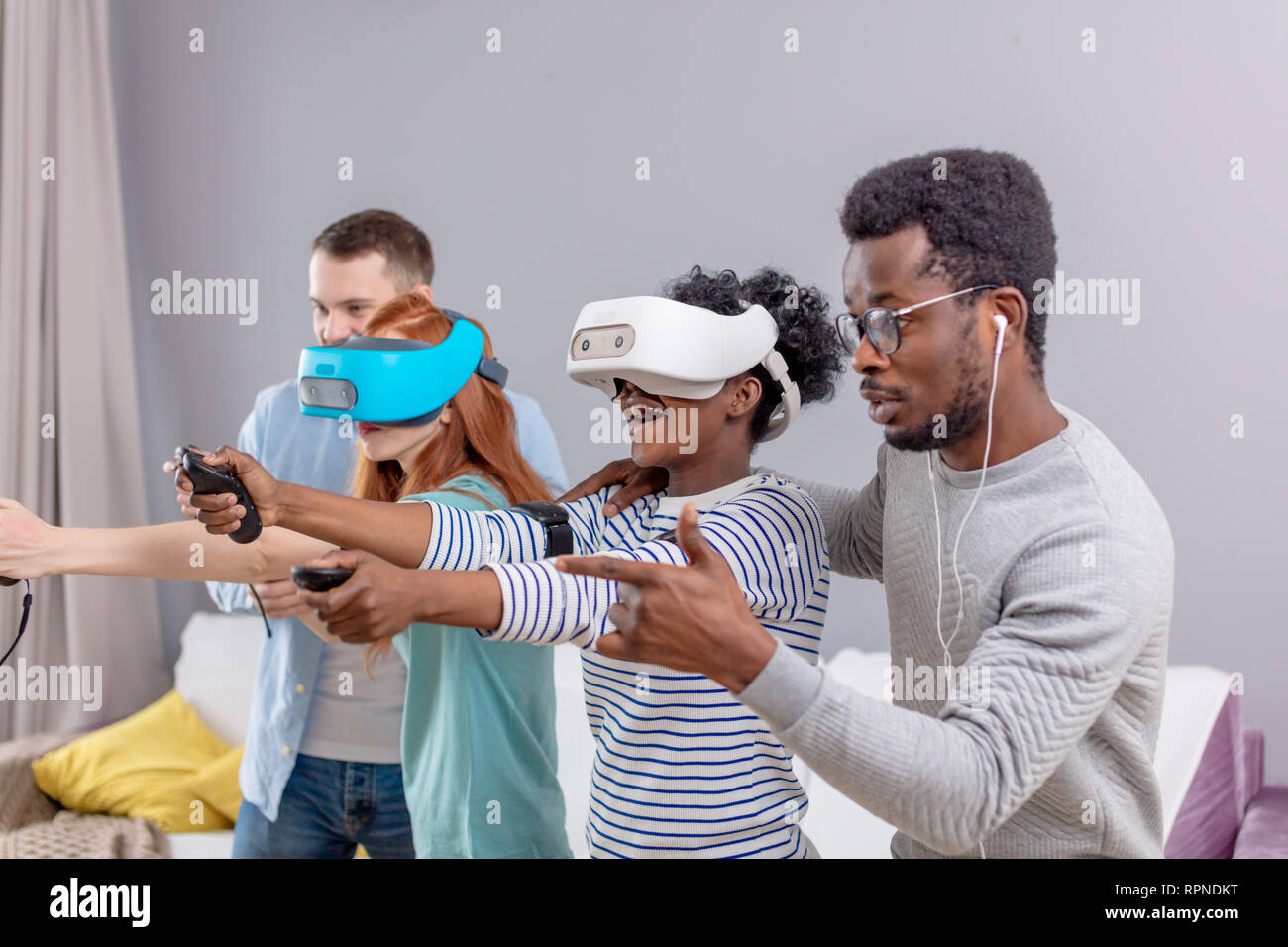 Group of young multicultural diverse friends play at home with internet ...