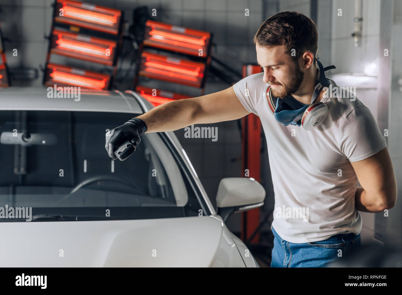 customer service. man working with a paint checker to test the depth of
