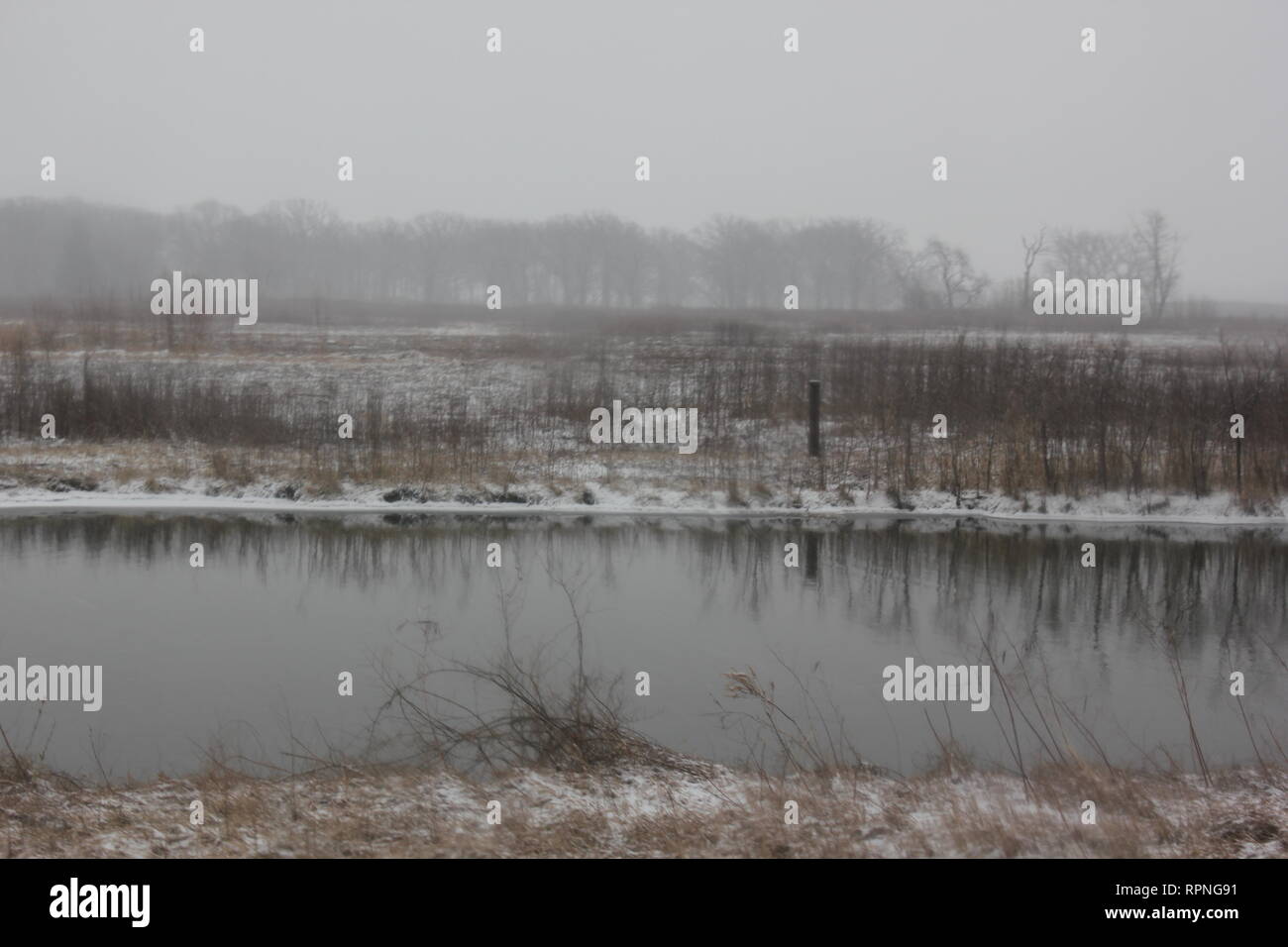 Blizzard Snowstorm winter landscape including the water cooling reservoir pool during a drive