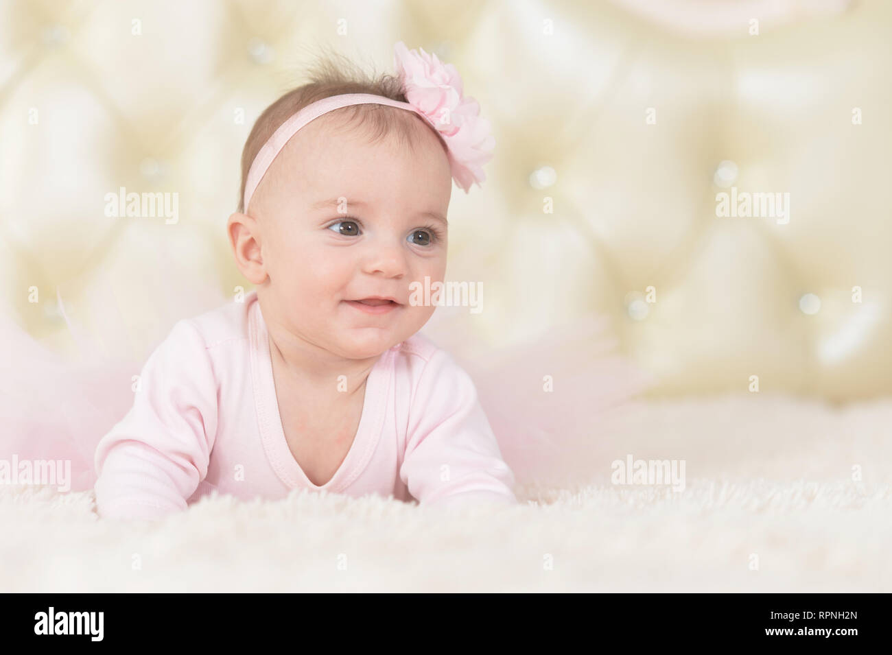 Cute charming girl in pink dress on bed at home Stock Photo - Alamy