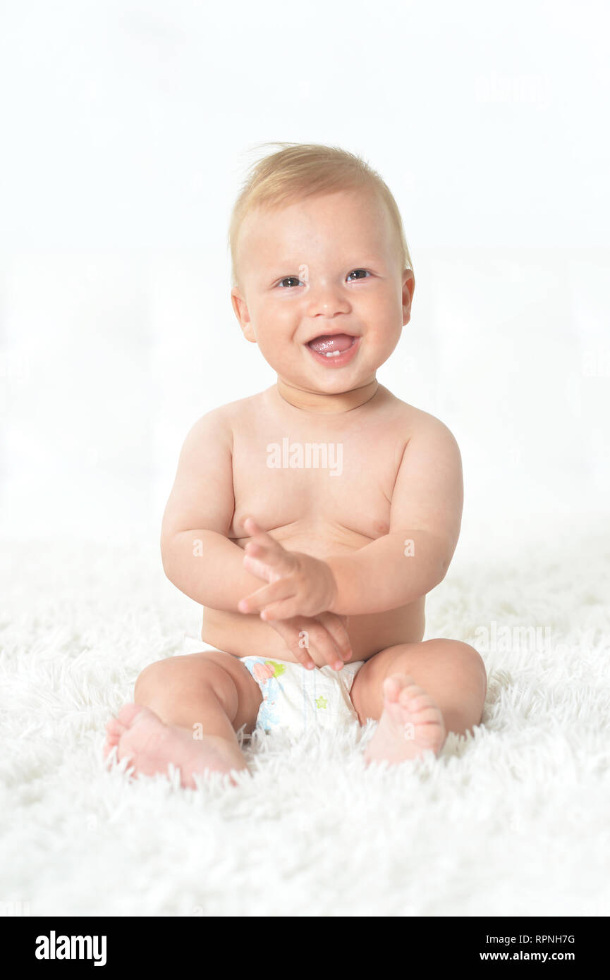 Portrait of cute beautiful baby boy on bed Stock Photo Alamy