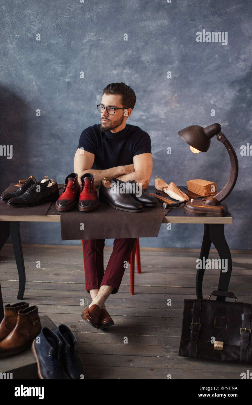 pensive good looking shoeshine man resting after working day. full
