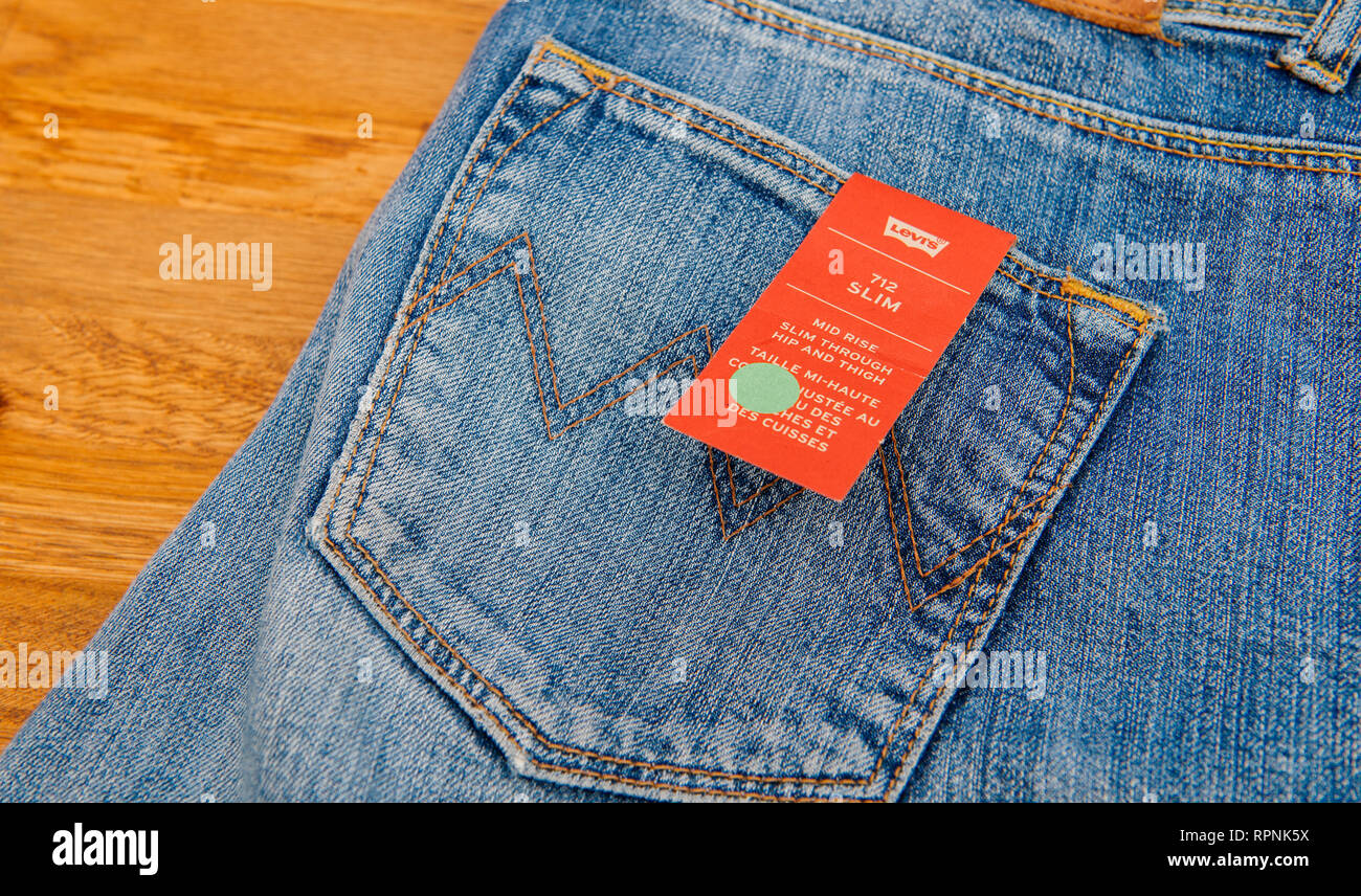 PARIS, FRANCE - JAN 2, 2018: New Jeans with price tag manufactured by the  Levi's placed on natural wooden table - model Vintage Soft Slim Stock Photo  - Alamy
