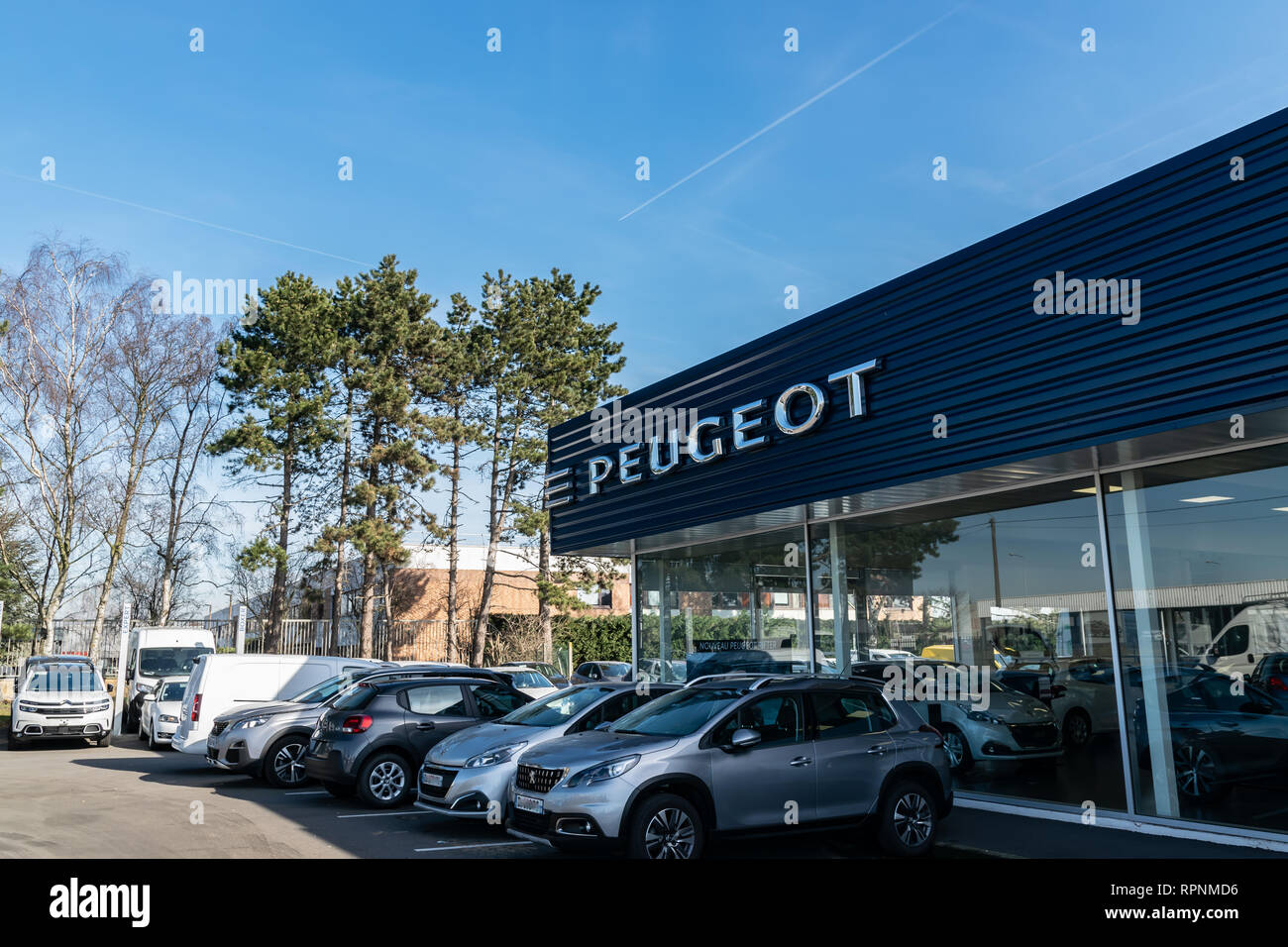 RONCQ,FRANCE-February 20,2019:Peugeot logo on the car dealership building. Stock Photo