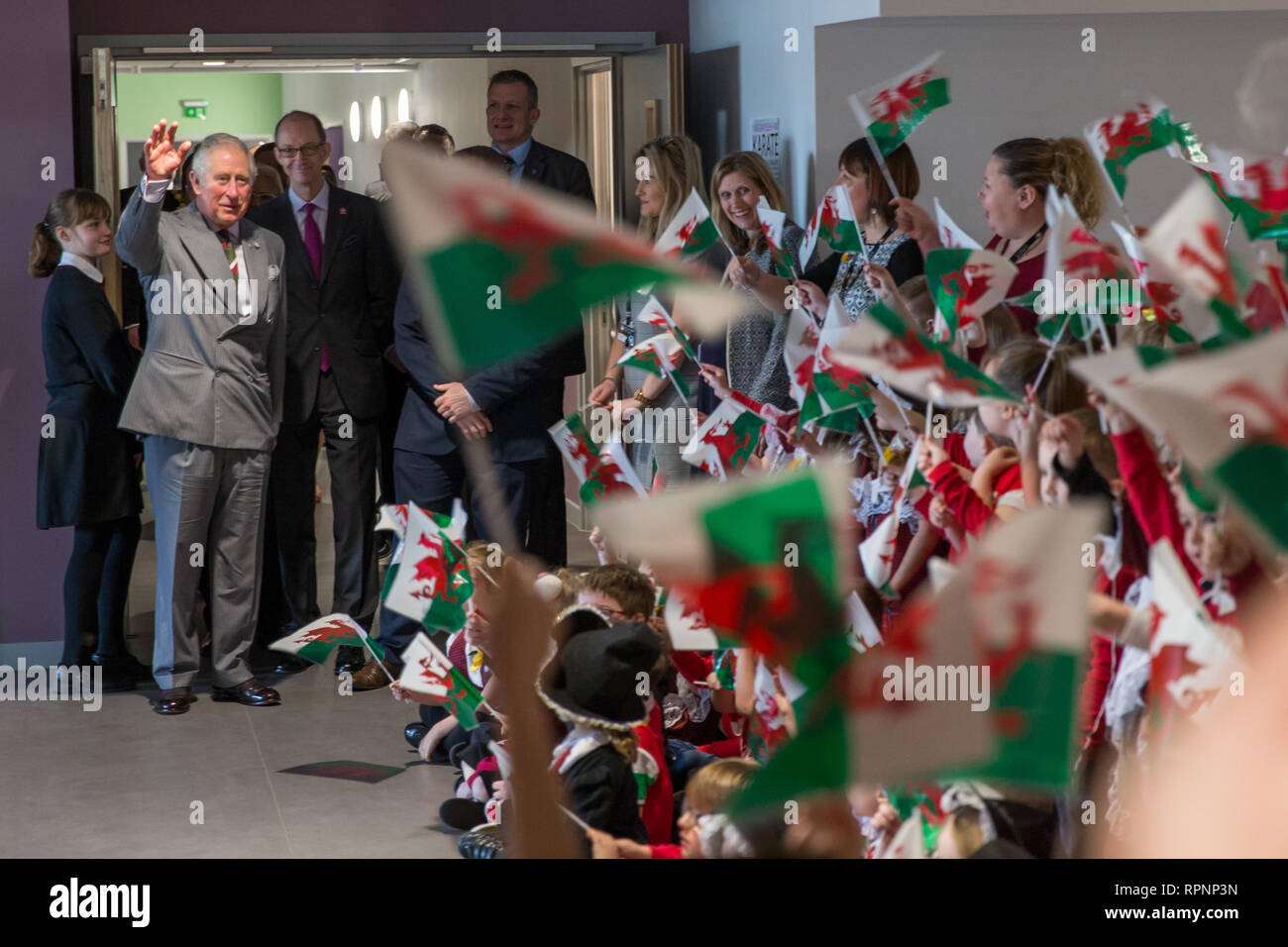 The Prince of Wales in his role of President, The Prince's Trust, waves goodbye to children after a visit Ysgol Cwm Brombil co-educational school in Port Talbot, Wales, which is involved in delivering The Trust's Achieve programme. Stock Photo