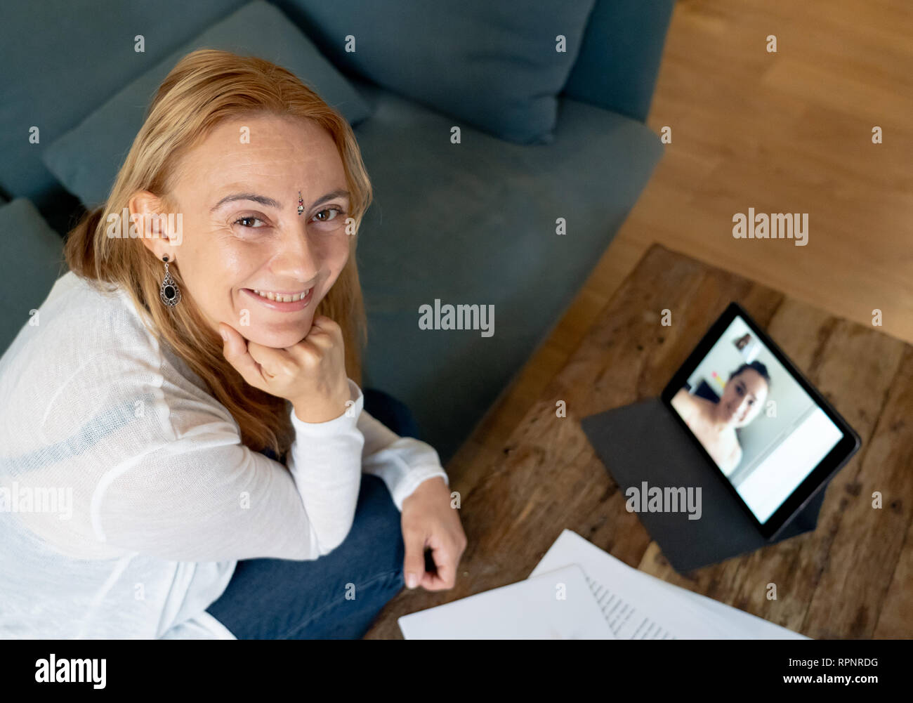 Attractive entrepreneur businesswoman attending video conference meeting on tablet at home in Electronic meeting Teleconference online consulting Vide Stock Photo