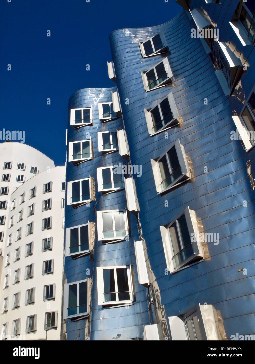 Silver Gehry building in Duesseldorf at the Media harbor, interesting architecture in Germany named Gehry-Bauten Stock Photo