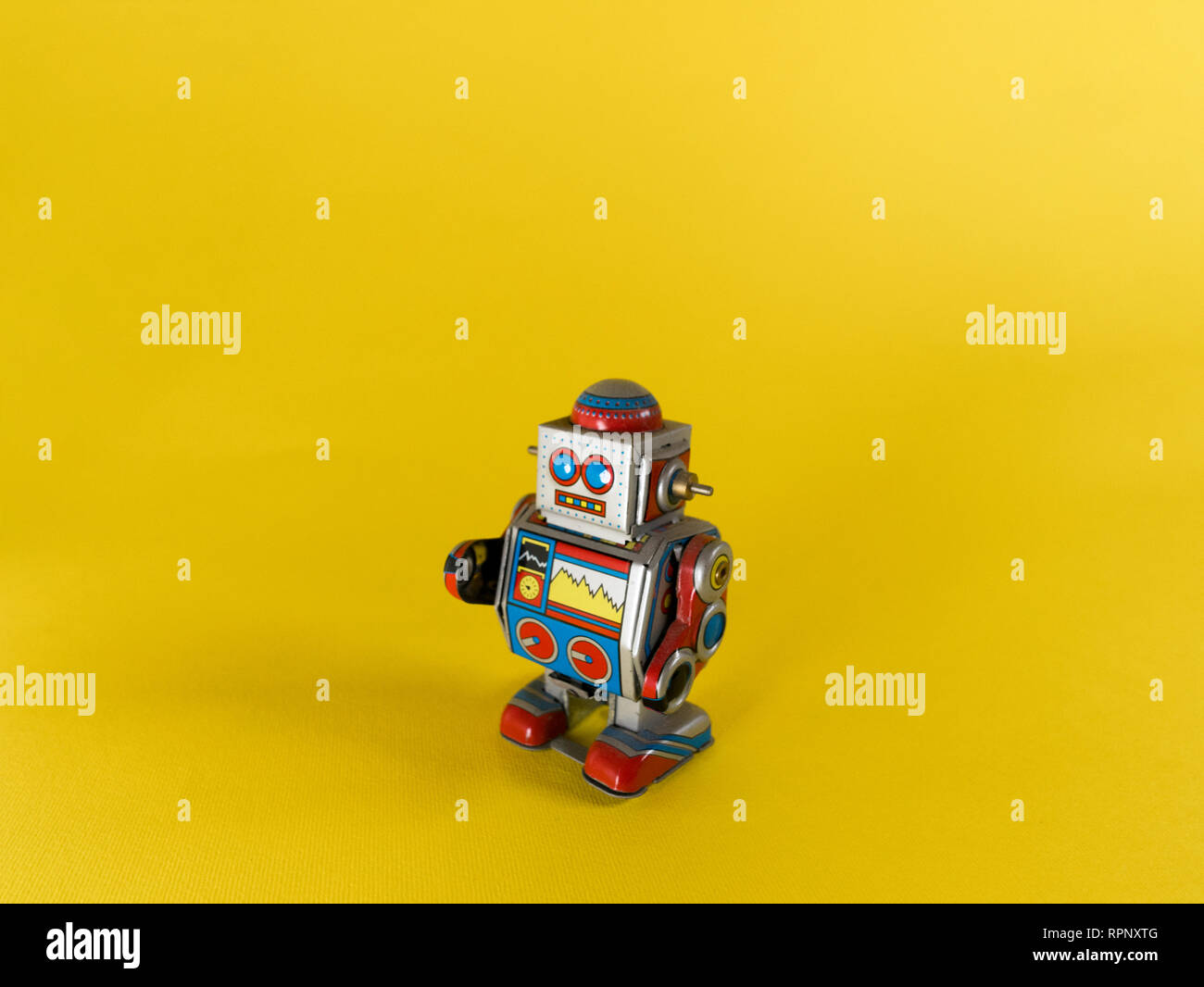 vintage metal robot on yellow background Stock Photo