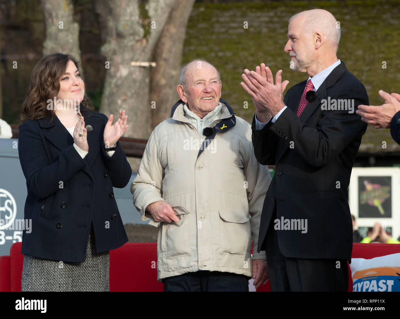 RETRANSMITTING CORRECTING NAME OF AIRMAN FROM GEORGE WILLIAMS TO MELCHOR HERNANDEZ CORRECT CAPTION BELOW Tony Foulds (centre), 82, is applauded by Megan Leo, cousin of airmen Melchor Hernandez, and Jim Kriegshauser, nephew of John Kriegshauser, who both died in the Mi Amigo crash, in Endcliffe Park in Sheffield, as warplanes from Britain and the United States stage a flypast tribute to ten US airmen 75 years after the crash that killed them. Stock Photo