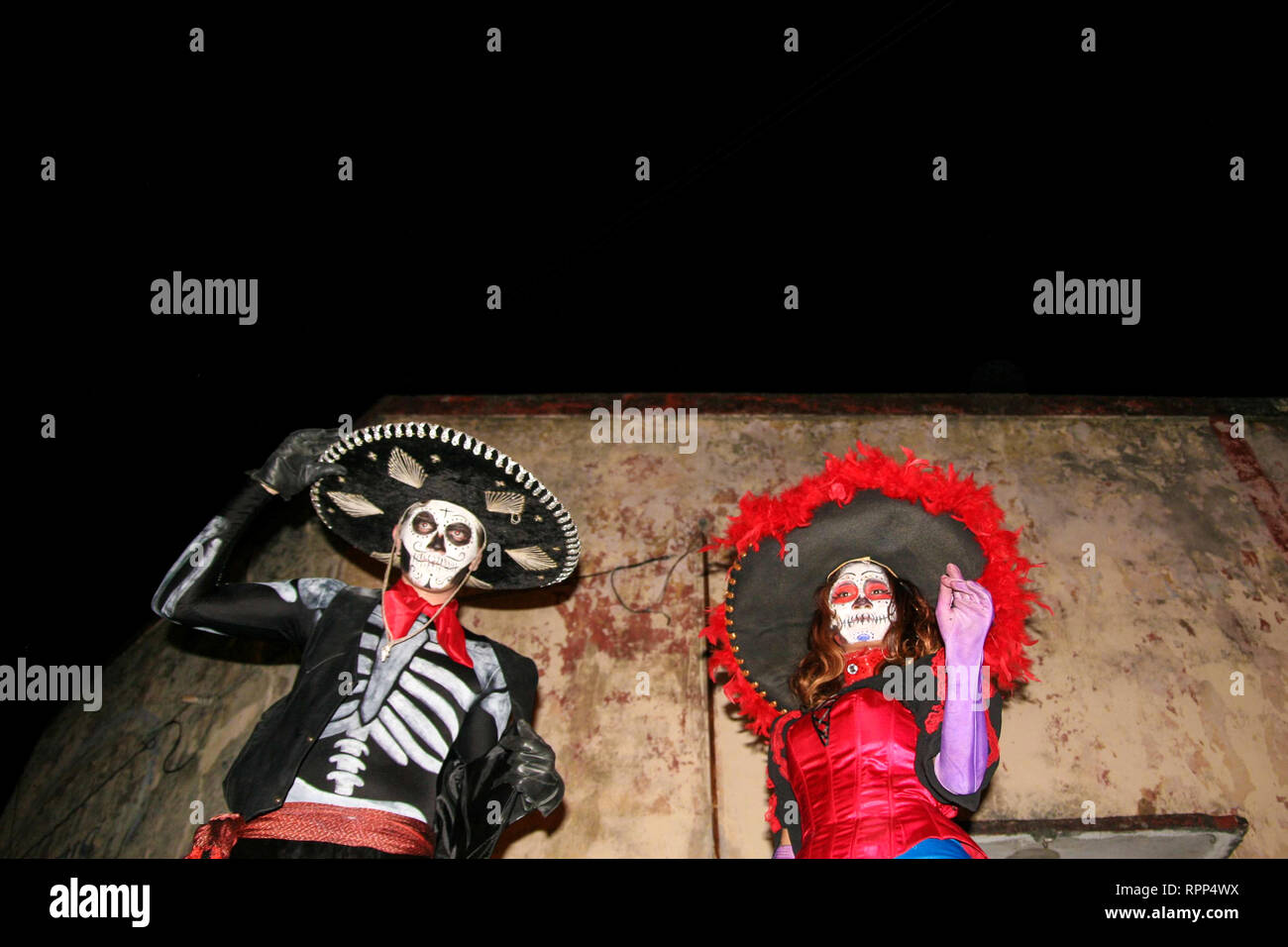 As mexican people are celebrating the day of the dead in the country, a couple heavily costumed is performing and entertaining tourists at the night e Stock Photo