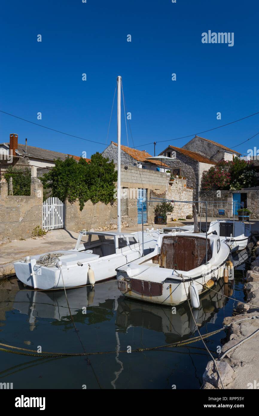 Wooden boats before own houses in Murter on Murter island, Dalmatia Croatia Stock Photo