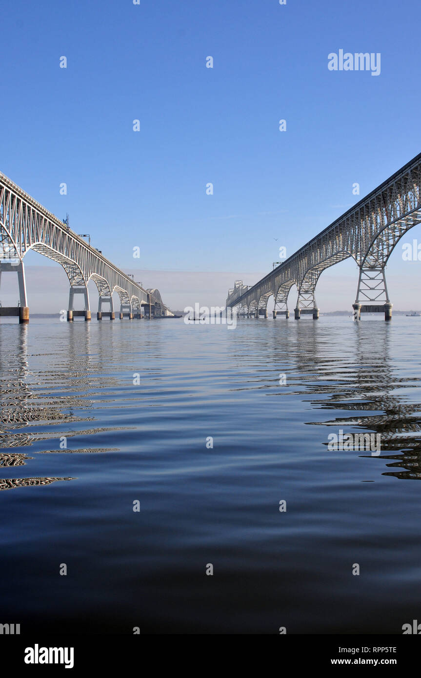 Both Spans of the Chesapeake Bay Bridge near Annapolis Maryland. It is a view right in the middle of the spans from the water. Stock Photo