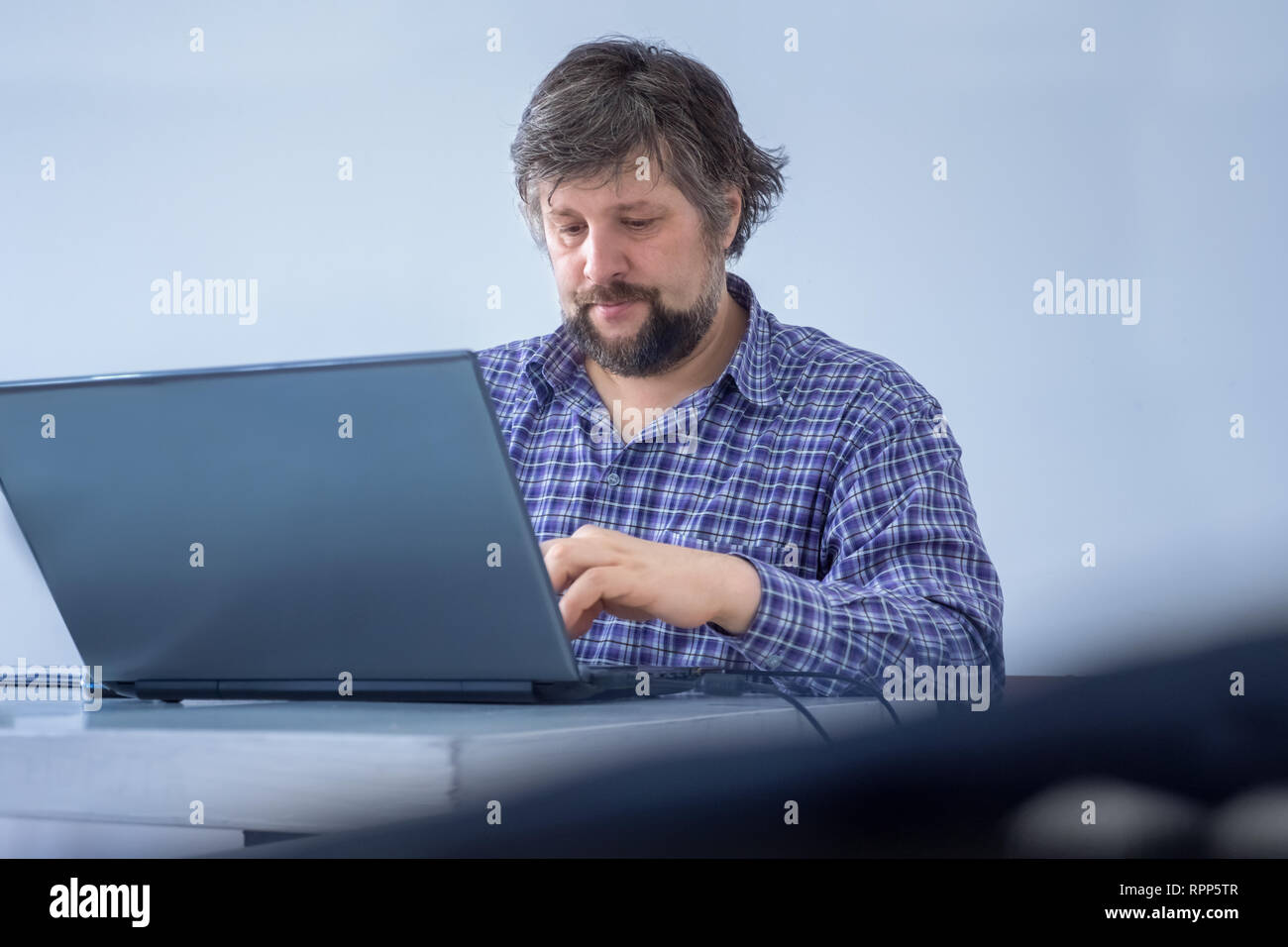 Male focussed on work. Working at home. Creative media marketing manager doing importnant tasks, have busy working schedule. Businessman dressed Stock Photo