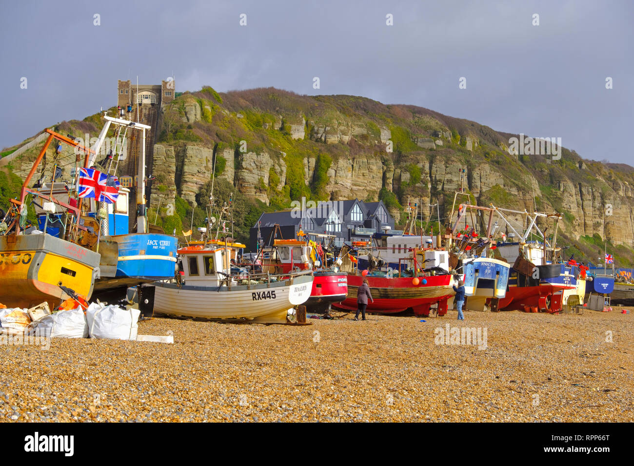 Hastings fishing trawlers pulled up high on the Old Town Stade beach on a stormy day in winter, East Sussex, UK Stock Photo