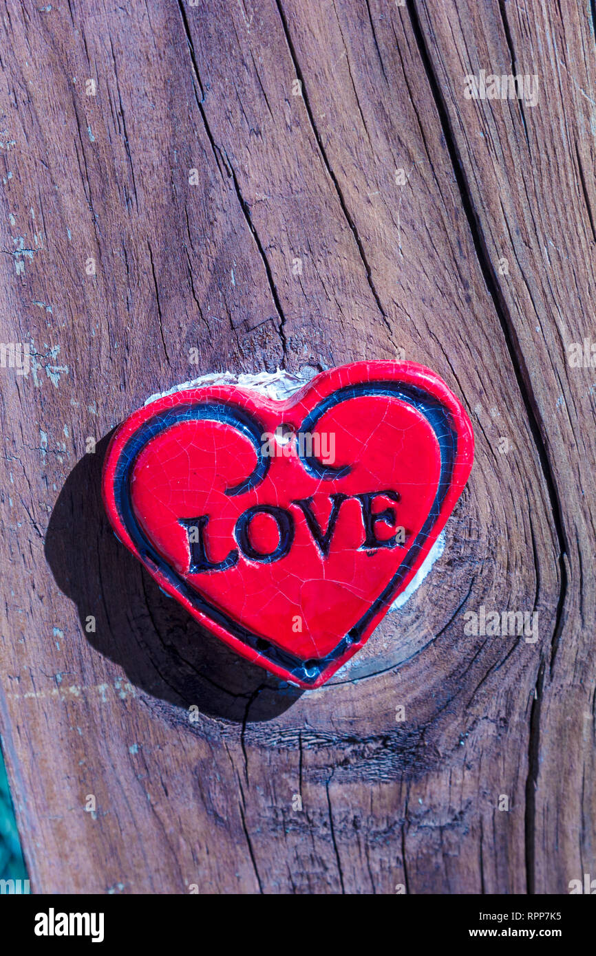 ceramic love heart on wooden board Stock Photo