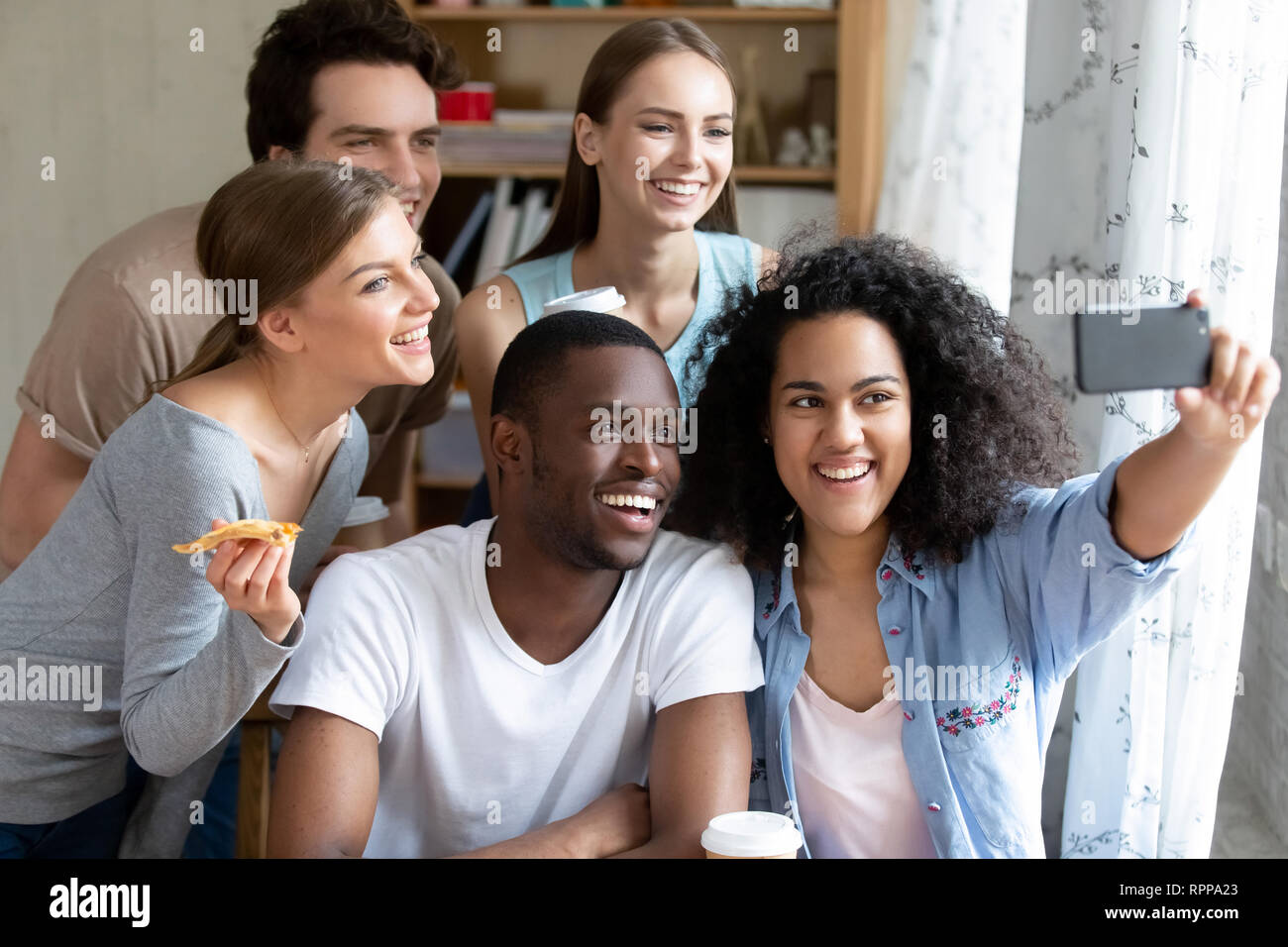 Happy smiling multiracial friends making selfie photo in pizzeria Stock ...