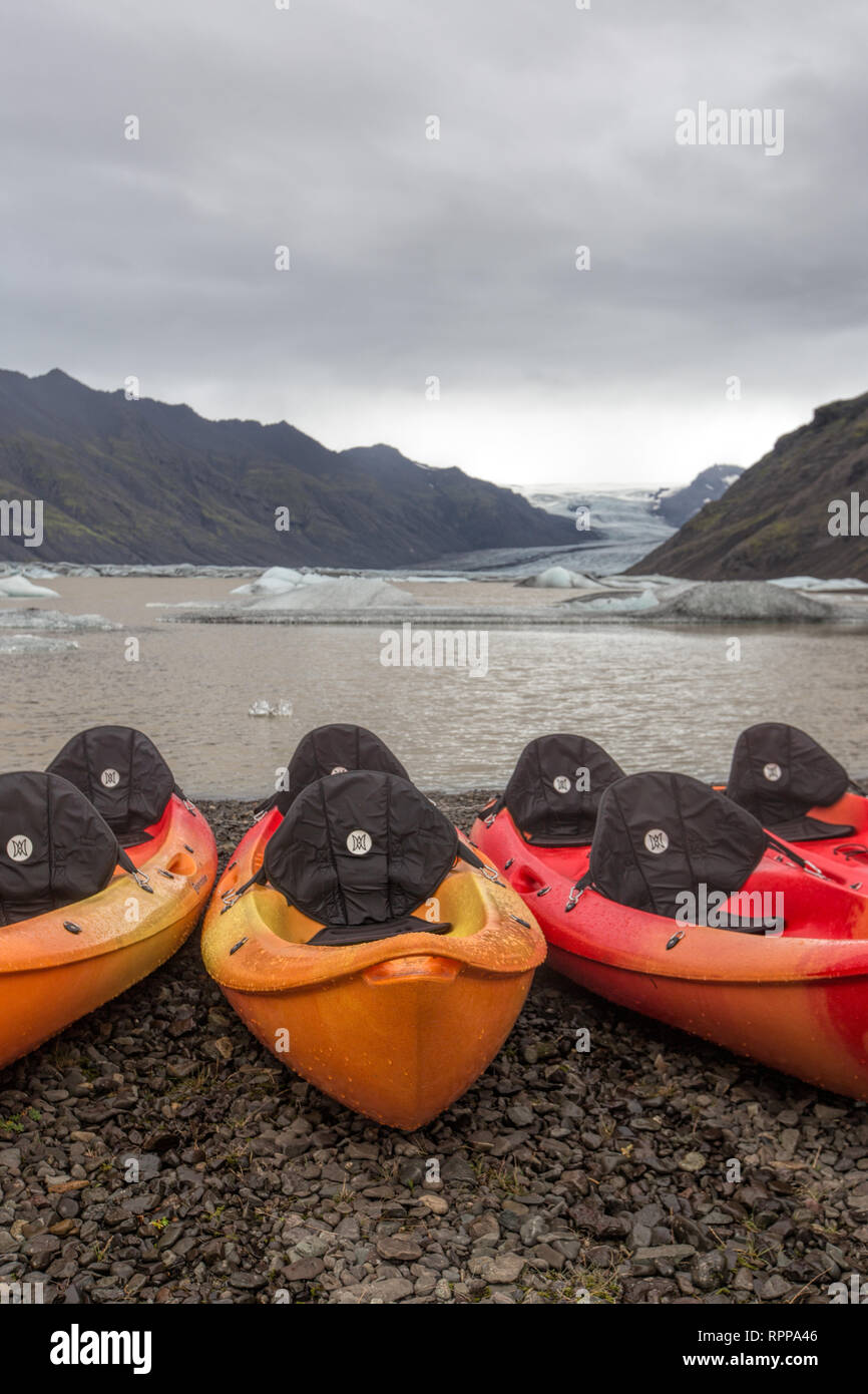 Kayaks lined up for an adventure on a glacial lake Stock Photo