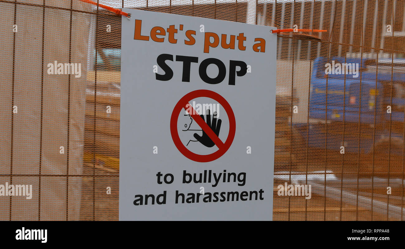 Warning sign on construction site stop bullying and harassment. Stock Photo