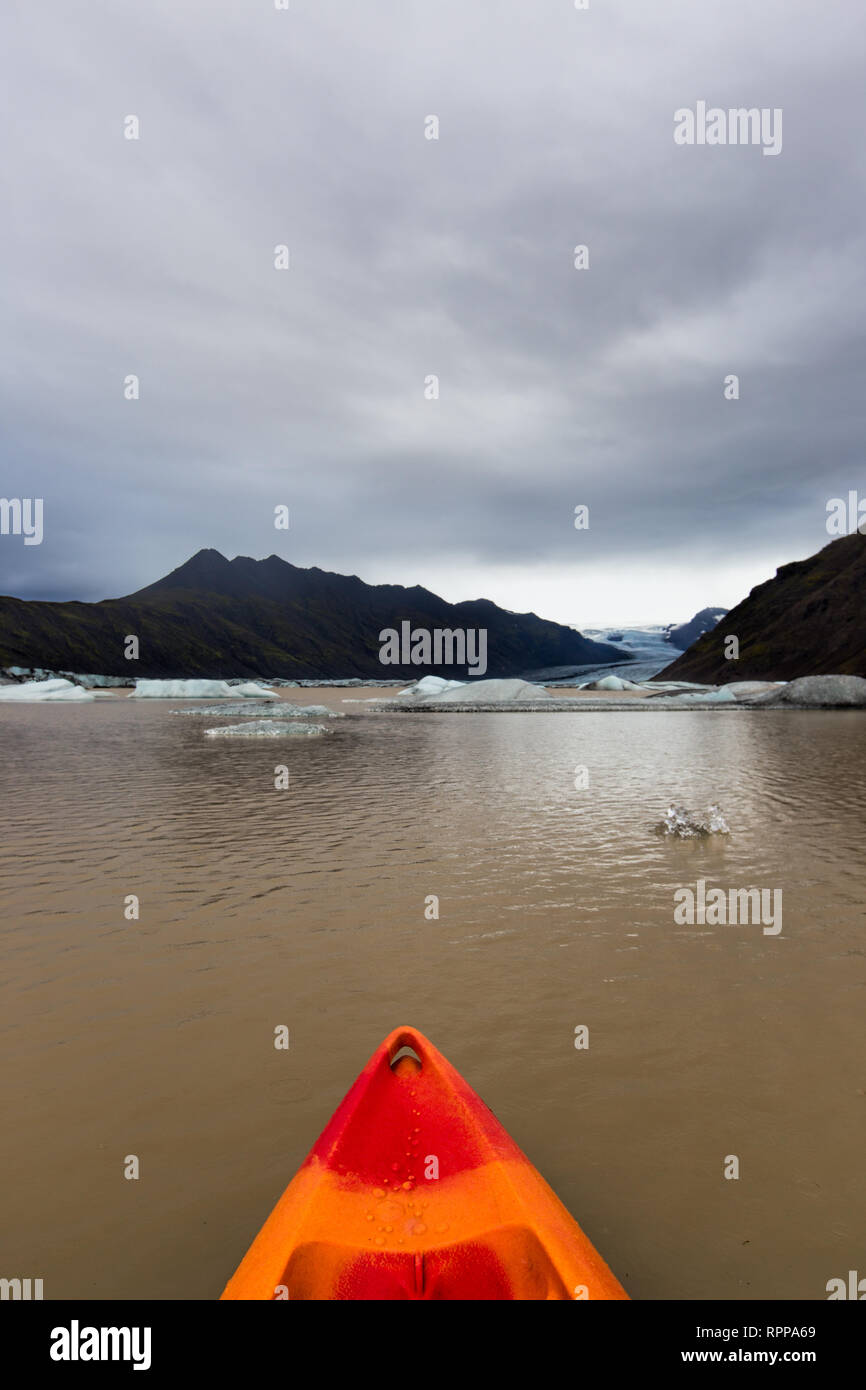 Looking out over the bow of a kayak on a glacial lake in Iceland Stock Photo