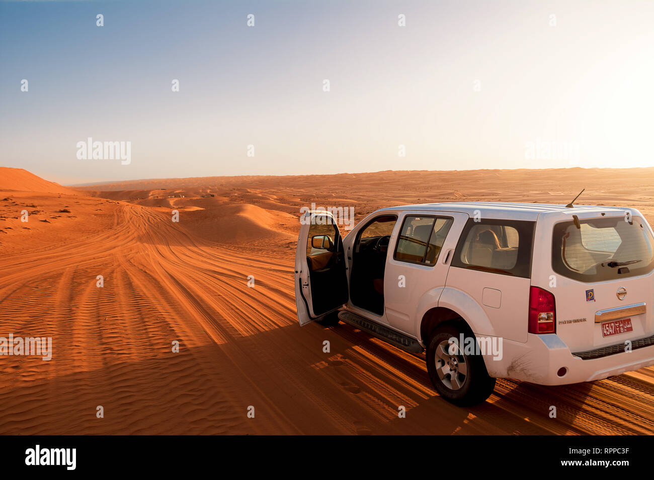 Bidiyah, Oman - November 5, 2018: Off-road vehicle in the wahiba sands desert dunes at sunset (Oman) Stock Photo
