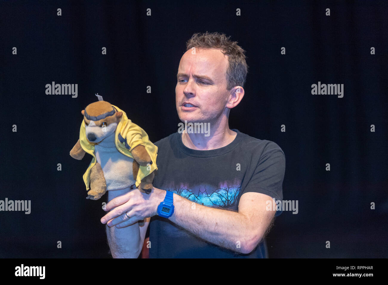 Brentwood, Essex, UK. 22nd February 2019. Half term literary activities for children with award winning children's authors Michelle Harrison and Gareth P Jones Gareth P Jones entertains children with a glove puppet of his book character the Ninja Meerkat, Credit: Ian Davidson/Alamy Live News Stock Photo
