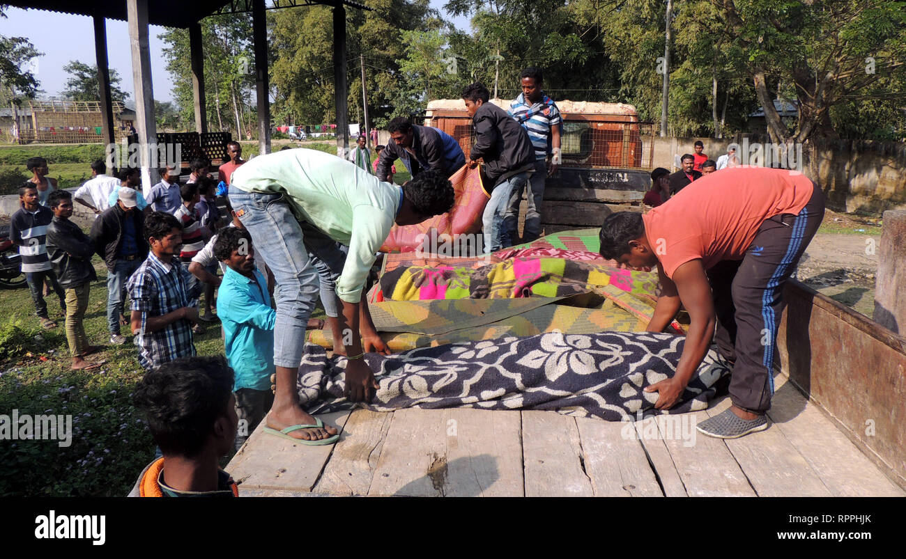 Assam. 22nd Feb, 2019. Locals arrange bodies of victims who died of consuming liquor mixed with methyl alcohol at Salmara tea garden at Golaghat district of India's north eastern state of Assam on Feb. 22, 2019. The death toll in India's north-eastern state of Assam rose to 22 on Friday, said media reports. Besides, as many as 50 people are being given medical treatment at different hospitals. Credit: Stringer/Xinhua/Alamy Live News Stock Photo