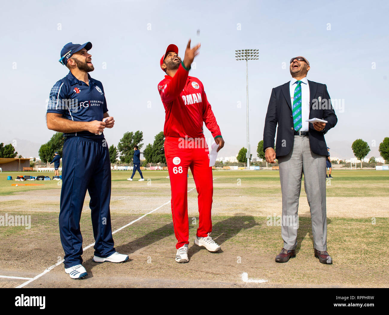 Muscat, Oman. 22nd Feb, 2019. Pic shows: Oman's Khawar Ali flips the coin as Scotland captain, Kyle Coetzer, and Match referee, former Sri Lankan international cricketer, Mr Graeme Labrooy, look on as Oman take on Scotland in the 3rd and final match of the 50 over series. Credit: Ian Jacobs/Alamy Live News Stock Photo