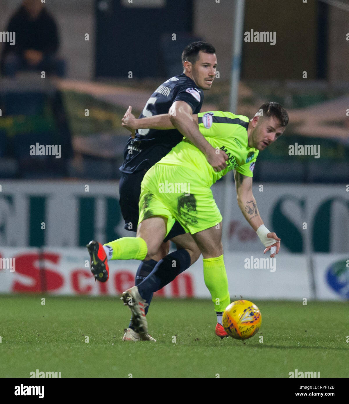 Dens Park, Dundee, UK. 22nd Feb, 2019. Ladbrokes Premiership football, Dundee v Hibernian; Ryan McGowan of Dundee challenges for the ball with Marc McNulty of Hibernian Credit: Action Plus Sports/Alamy Live News Stock Photo