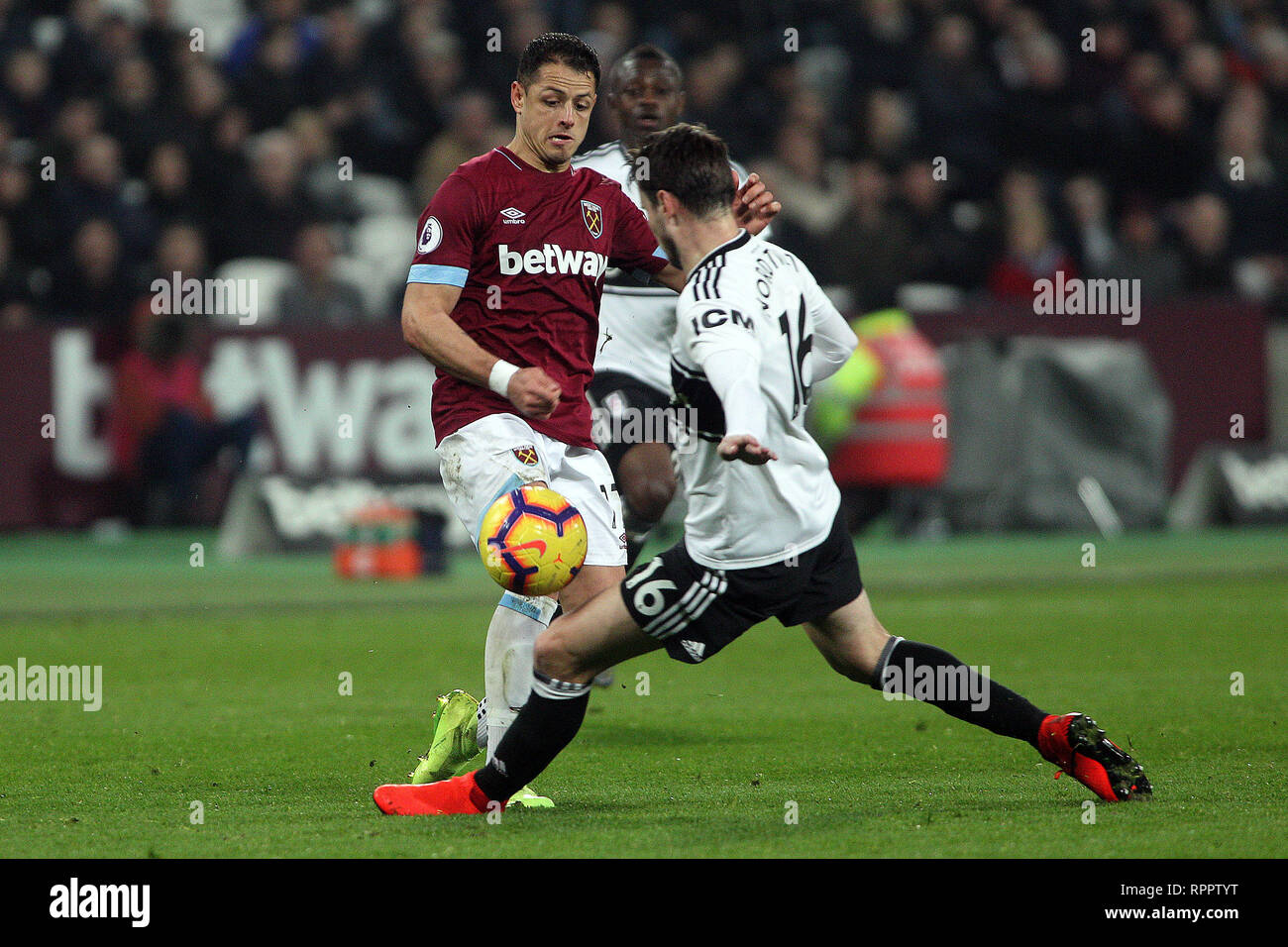 London, UK. 22nd Feb 2019. Javier Hernandez of West Ham United (L) plays the ball off Havard Nordtveit of Fulham's (R) arm. Premier League match, West Ham United v Fulham at the London Stadium, Queen Elizabeth Olympic Park in London on Friday 22nd February 2019.  this image may only be used for Editorial purposes. Editorial use only, license required for commercial use. No use in betting, games or a single club/league/player publications . pic by Steffan Bowen/Andrew Orchard sports photography/Alamy Live news Stock Photo