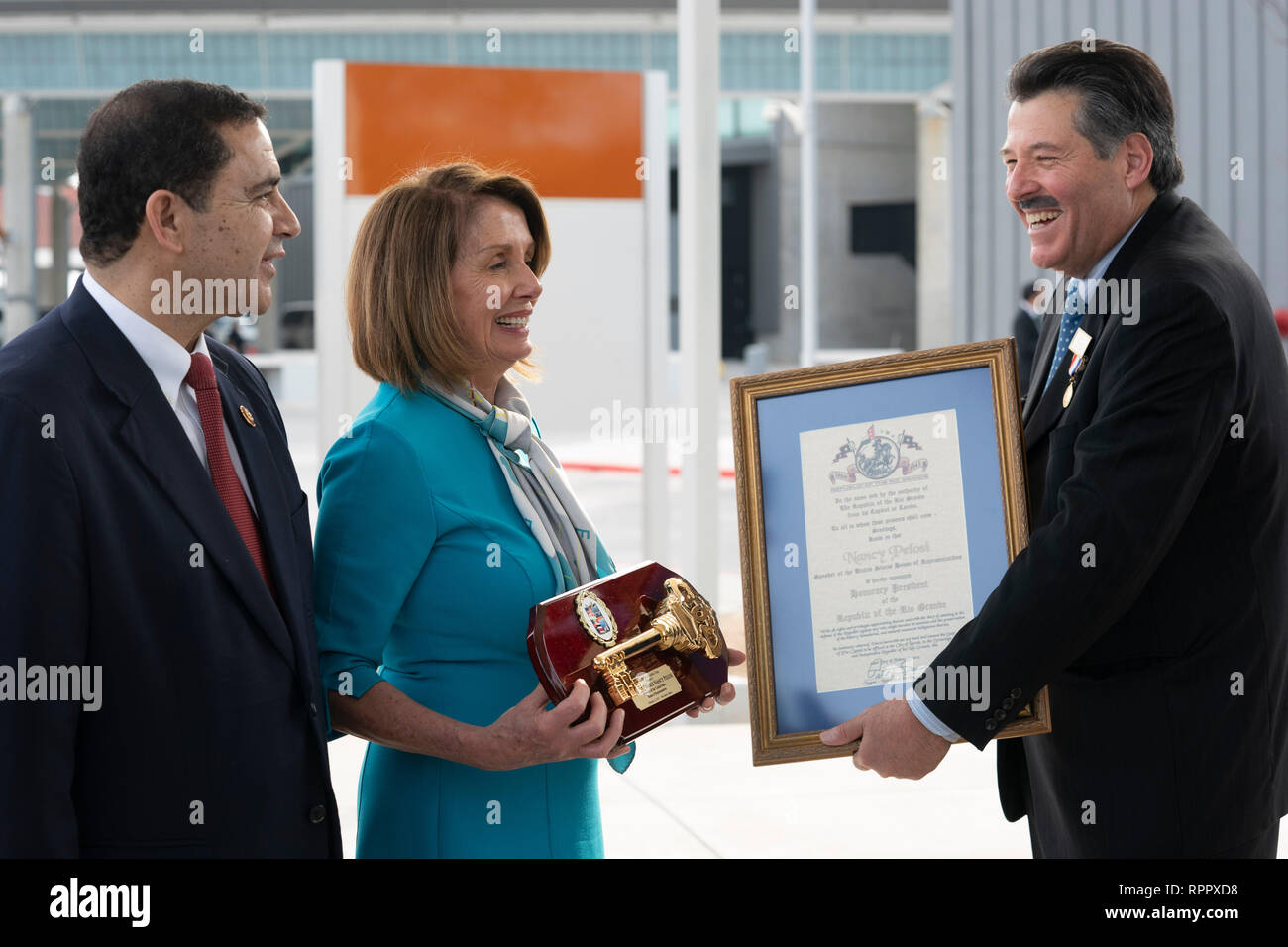 United States House of Representatives Speaker Nancy Pelosi (D-CA), receives a key to the city and ceremonial citation from Laredo Mayor Pete Saenz, right, as Laredo Congressman Henry Cuellar looks on during a press conference at the border between Laredo and Nuevo Laredo, Tamaulipas, Mexico. Stock Photo