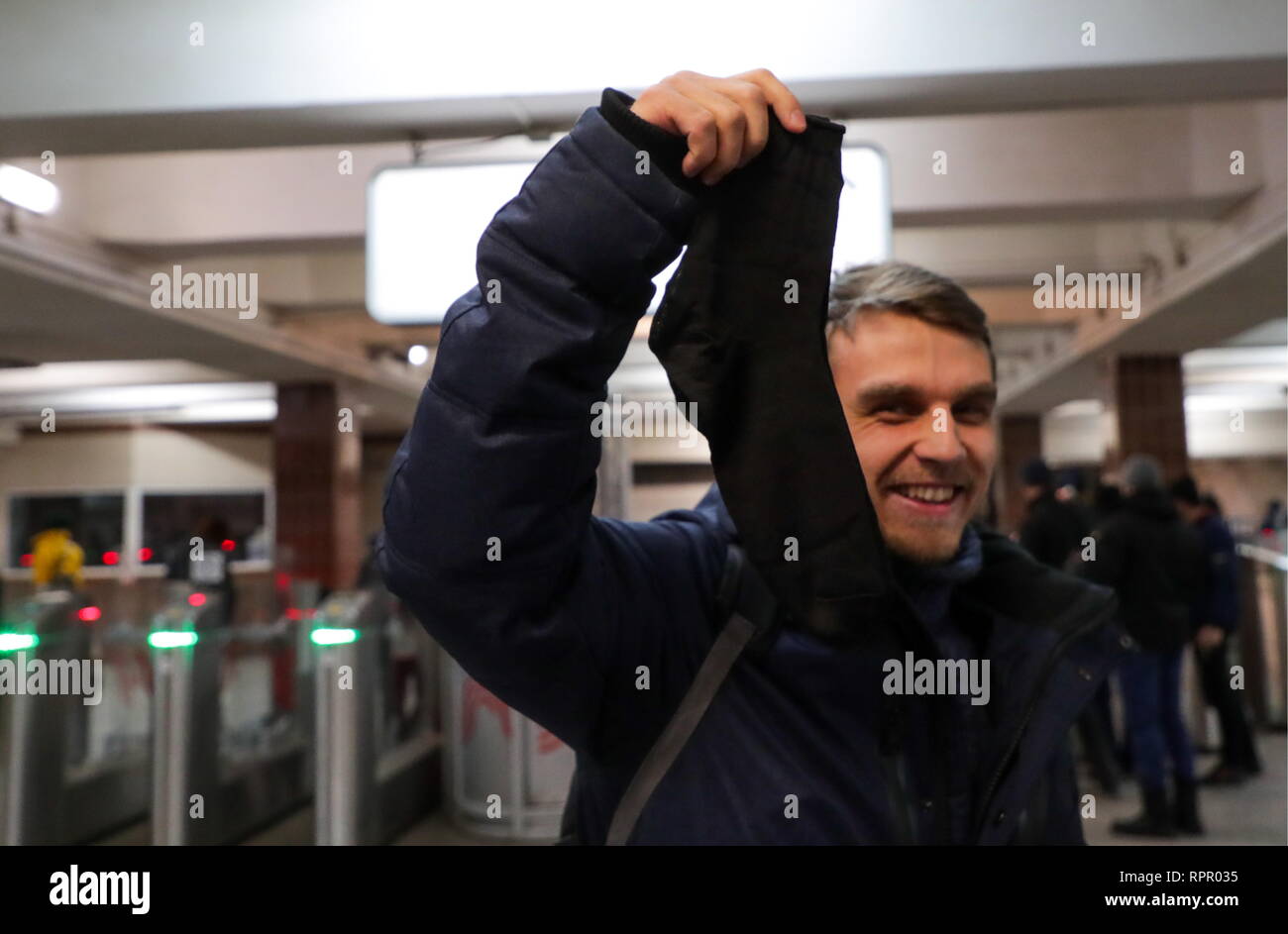 Moscow, Russia. 23rd Feb, 2019. A man shows a pair of socks given to him at the Komsomolskaya station of the Moscow Metro on Defender of the Fatherland Day. Vyacheslav Prokofyev/TASS Credit: ITAR-TASS News Agency/Alamy Live News Stock Photo