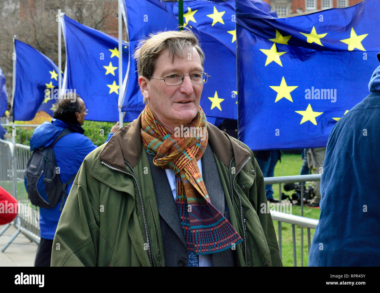 Dominic Grieve MP (Conservative: Beaconsfield) former Attorney General, walking past EU flags on College Green, Westminster, on the day that he was r Stock Photo