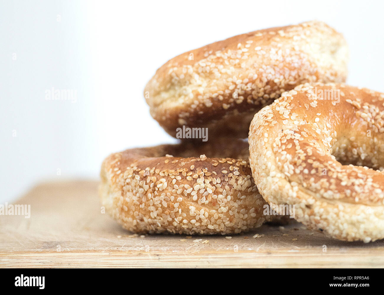 Montreal sesame seed bagels are shown on a cutting board Stock Photo