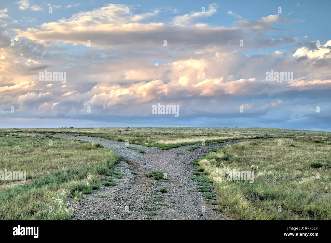 In Colorado a road forks in the wide expanse of the short grass prairie portion of the Great Plains. Stock Photo