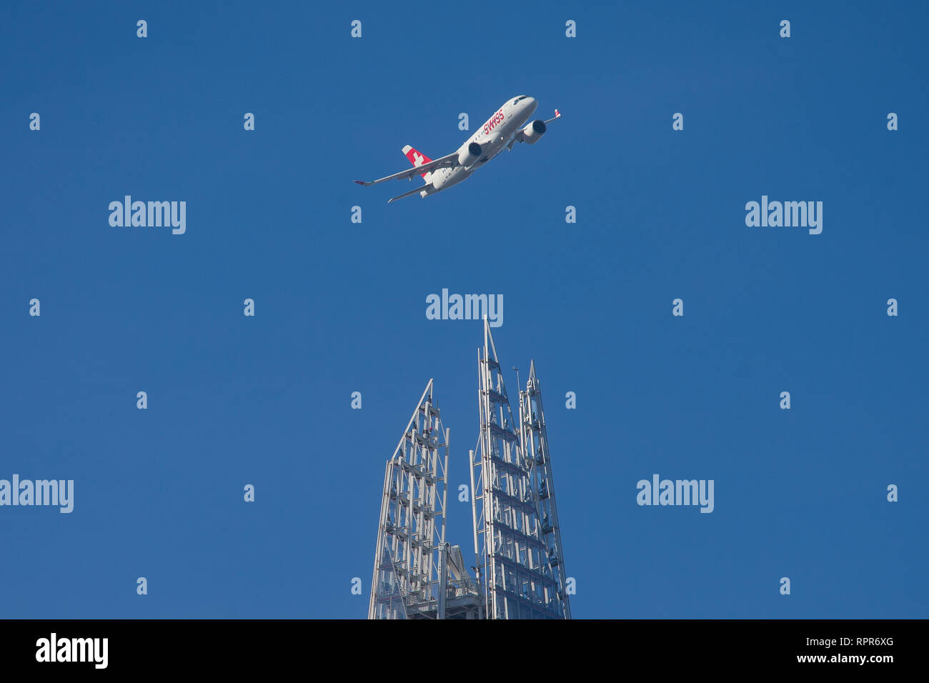 A Swiss airlines plane banks above the Shard on approach to LCY City airport. Stock Photo