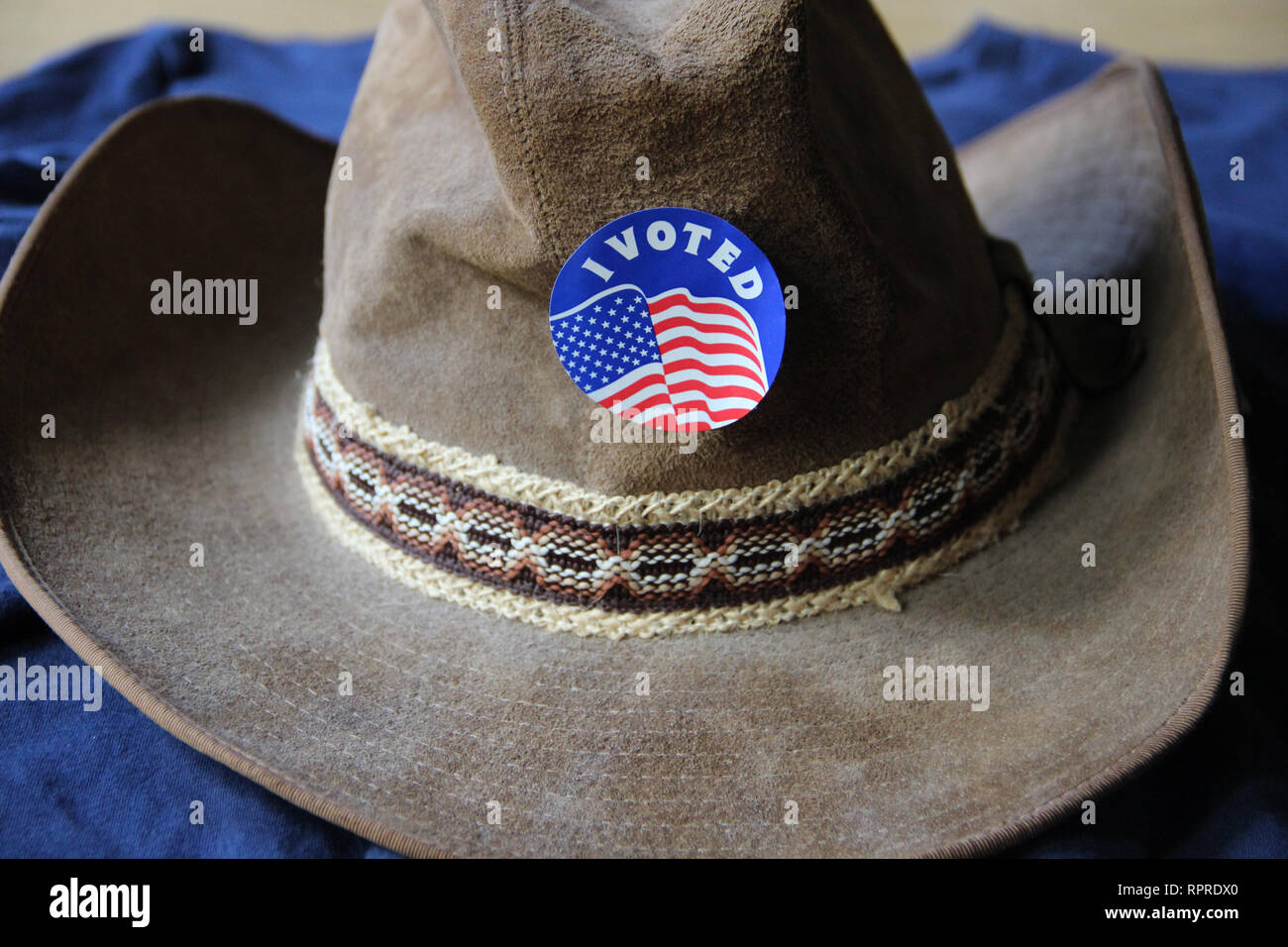'I Voted' sticker is proudly worn on a cowboy hat after voting in the 2018 election in Texas. Stock Photo