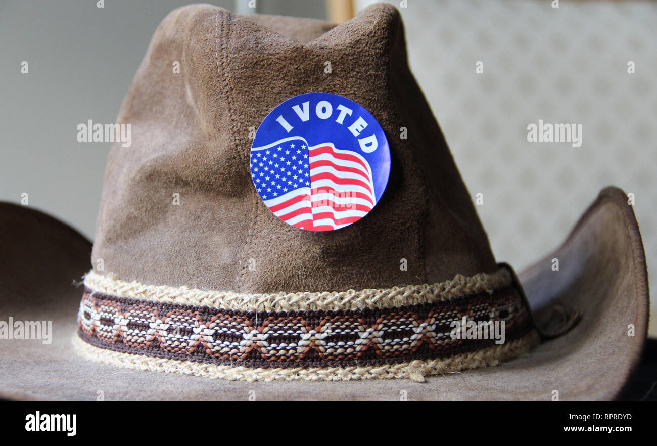 'I Voted' sticker is proudly worn on a cowboy hat after voting in the 2018 election in Texas. Stock Photo