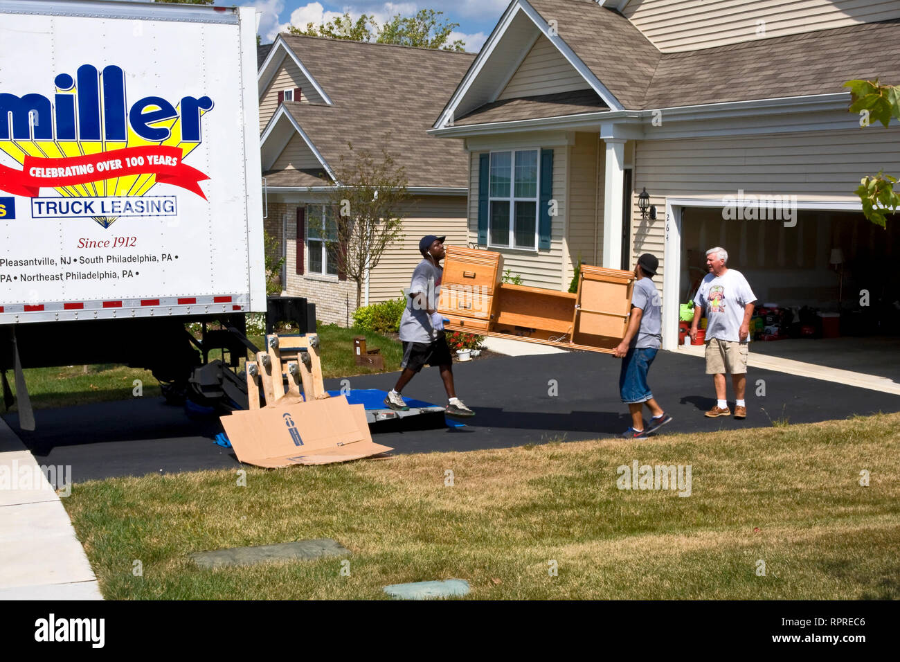 moving, house; truck; 2 men, carrying desk; homeowner; occupation; heavy work; physical, new beginning; summer; horizontal; MR Stock Photo