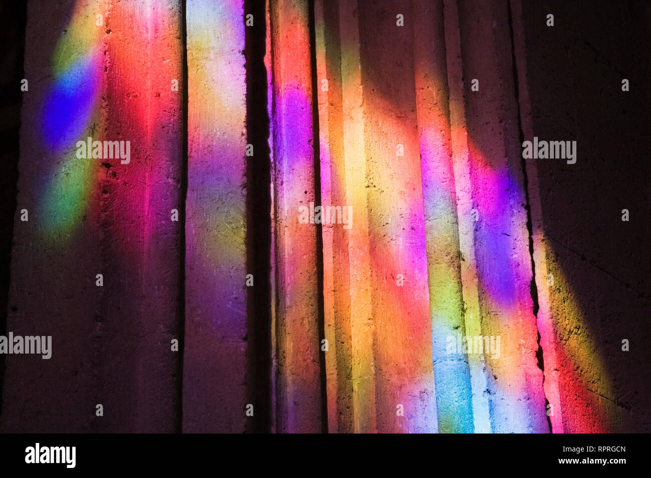 Colourful light reflections on a cement pillar Stock Photo
