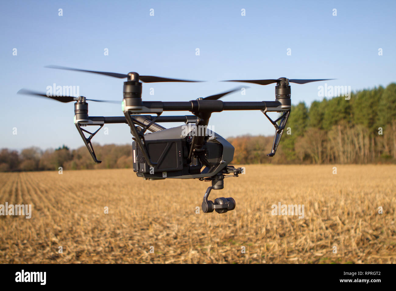 Drone quadcopter with flying above crop conducting survey Stock Photo