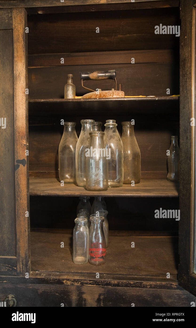 Close Up Of Some Old Milk Bottles Inside An Antique Dresser In The