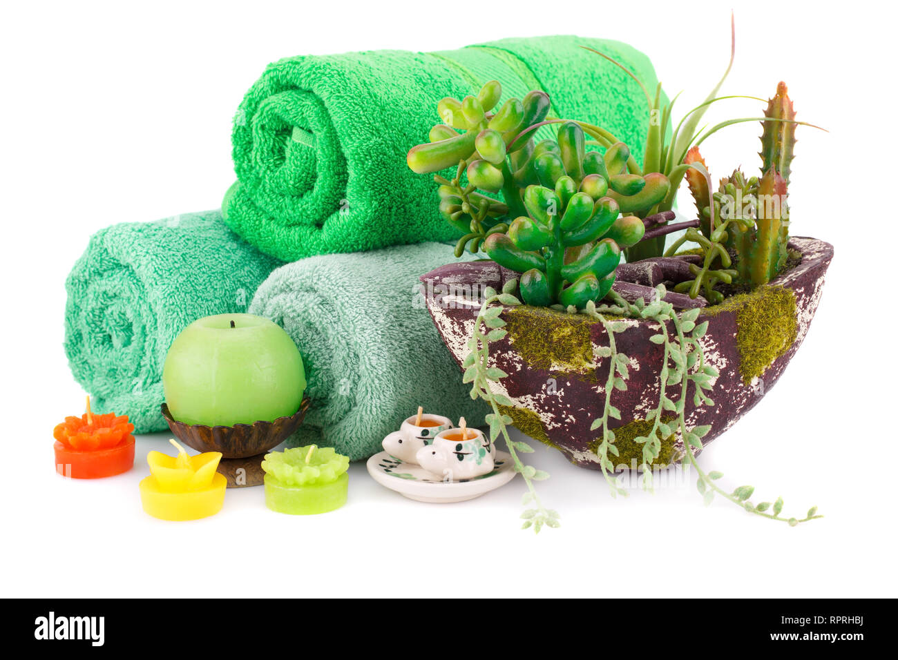 Spa set with towels, candles and plant in vase isolated on white background. Stock Photo
