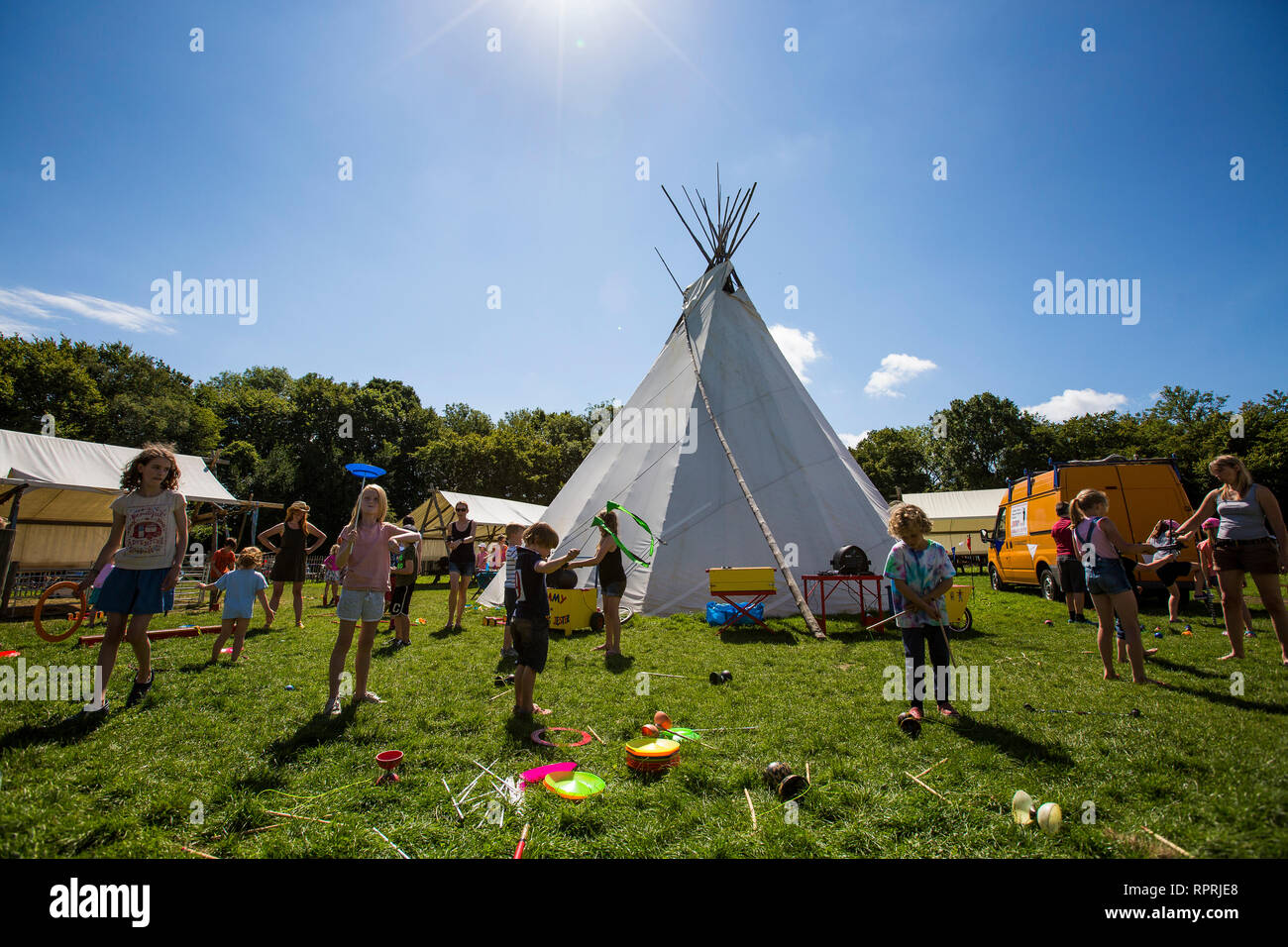 Fun and games at circus school at the tipi at Wowo's campsite, Sussex, UK Stock Photo