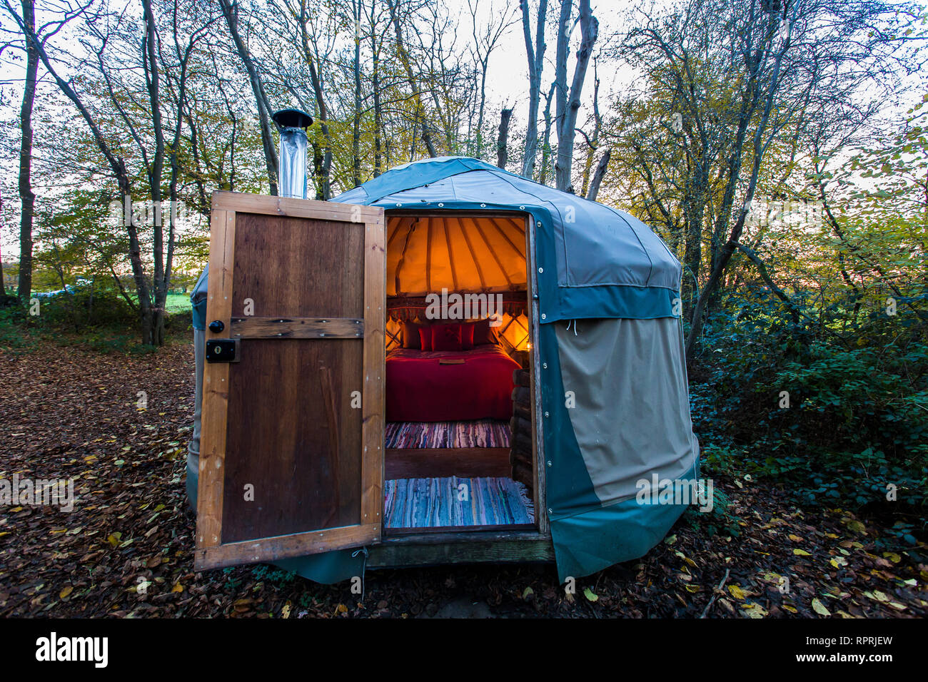 Traditional yurt in the woods, glamping in Autumn / Winter Stock Photo