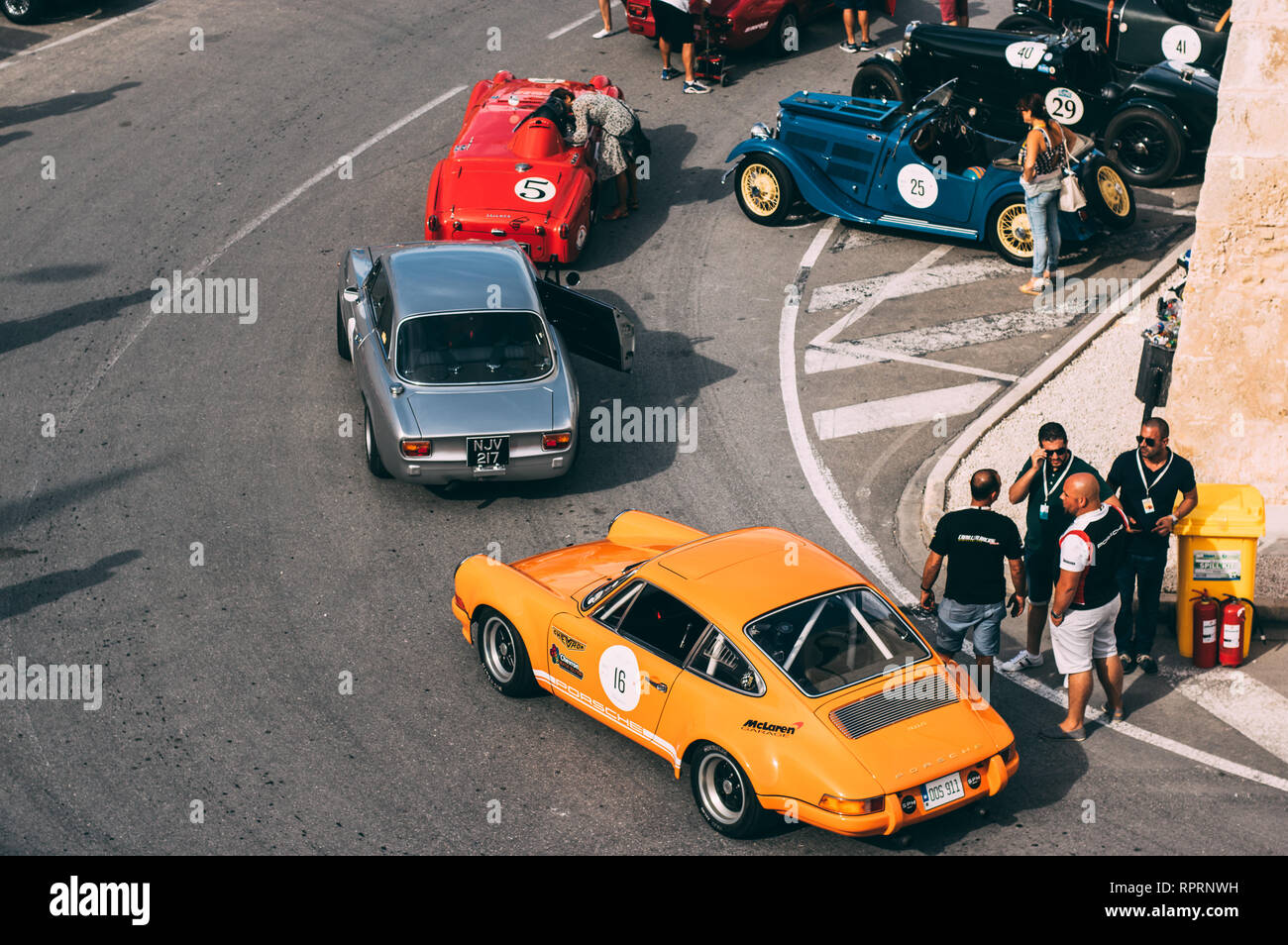 Mdina, Malta - 2016.10.08:  Malta Classic Grand Prix, yellow Porsche 911s, red Triumph Stock Photo