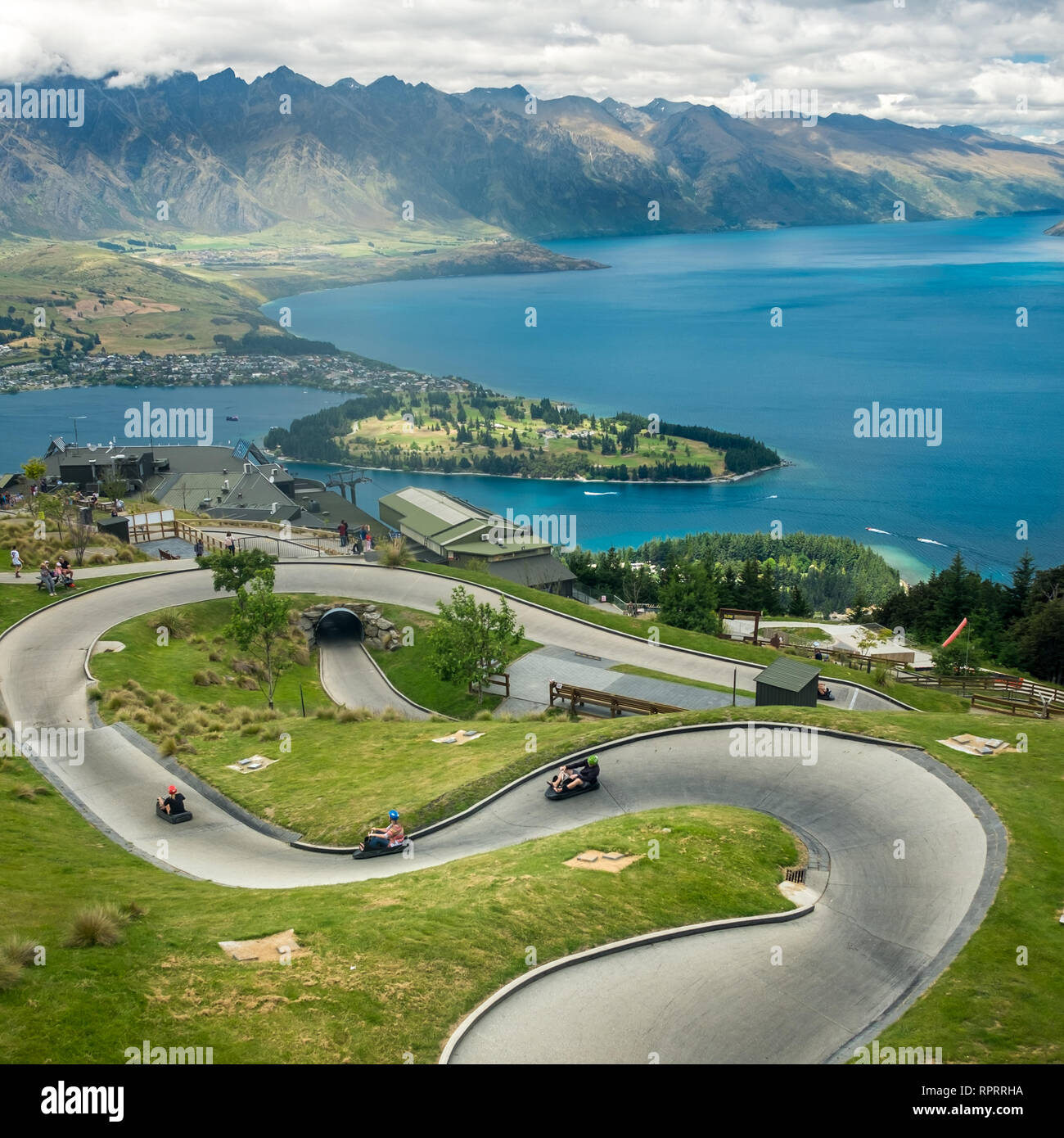 Luge track with mountains in the background at Queenstown Skyline site, New Zealand. Stock Photo