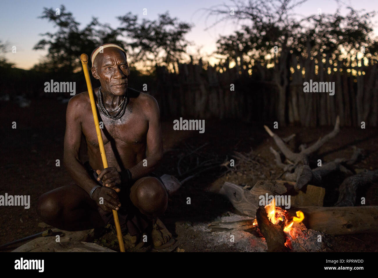 Zemba people Zemba chief near camp fire at sunset, vilagge near Epupa, Namibia, Africa Stock Photo