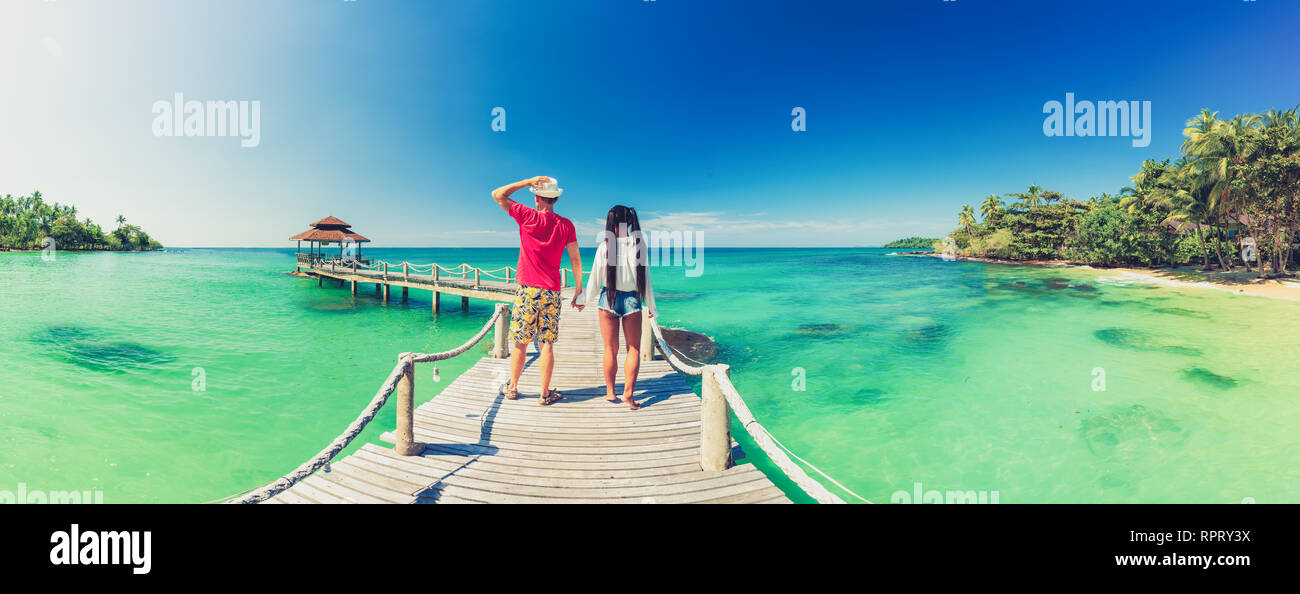 Beautiful young couple relaxing on an exotic beach from Seychelles. Couple in love travel on honeymoon on exotic island Stock Photo