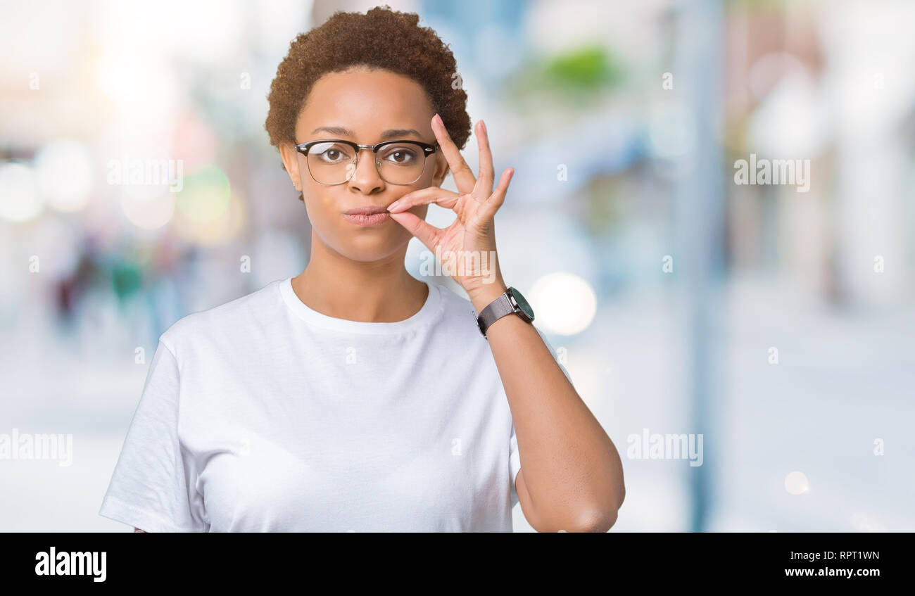 Beautiful young african american woman wearing glasses over isolated ...