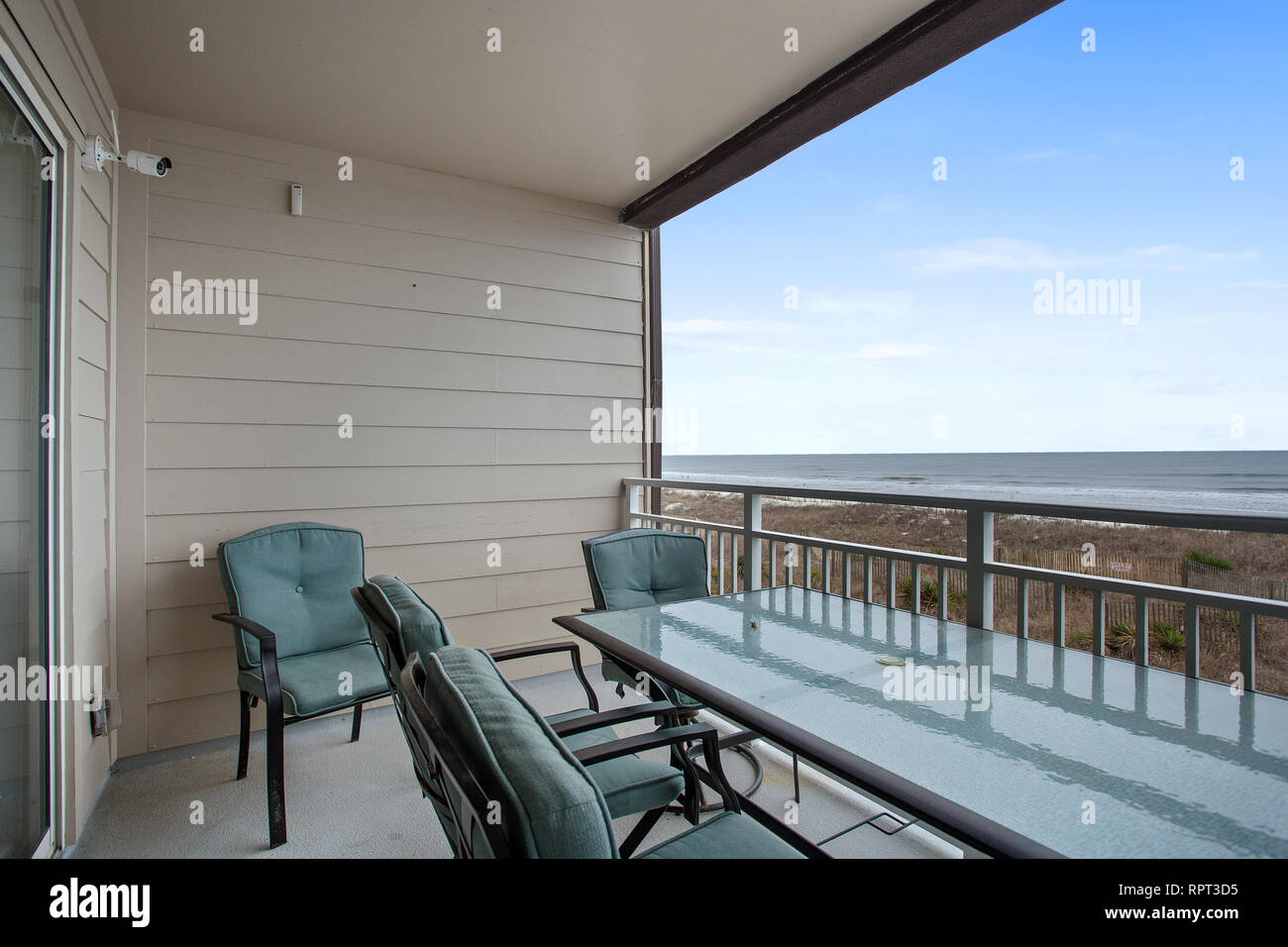 View Of Beach Apartment Balcony Empty With Table And